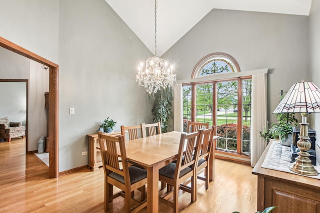 3840 W Nettle Creek Dr, Morris, IL 60450 - dining room with high vaulted ceiling, light wood-style floors, and a chandelier