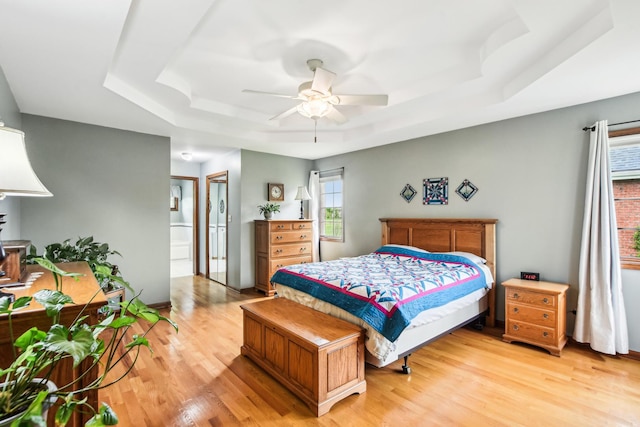 3840 W Nettle Creek Dr, Morris, IL 60450 - bedroom with a tray ceiling, light wood-type flooring, a ceiling fan, and ensuite bath
