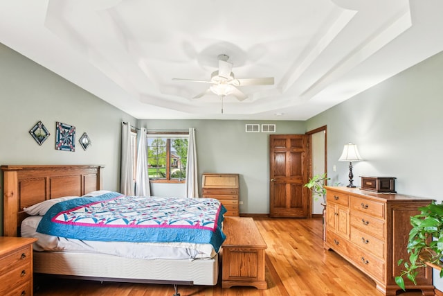 3840 W Nettle Creek Dr, Morris, IL 60450 - bedroom featuring a tray ceiling, light wood-style floors, and ceiling fan