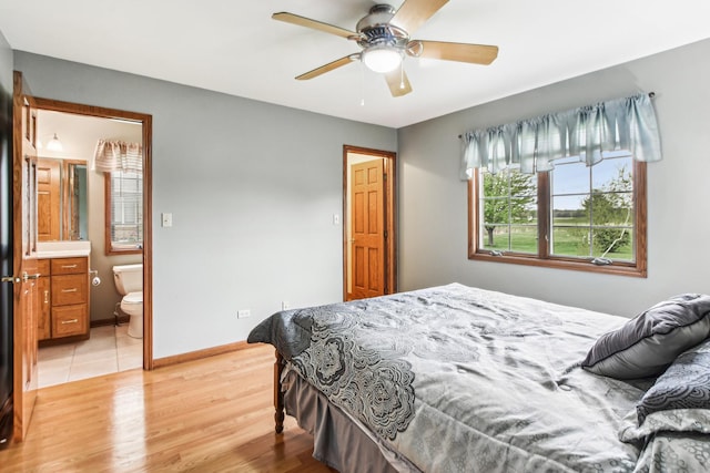 3840 W Nettle Creek Dr, Morris, IL 60450 - bedroom featuring light wood-type flooring, baseboards, ensuite bathroom, and a ceiling fan