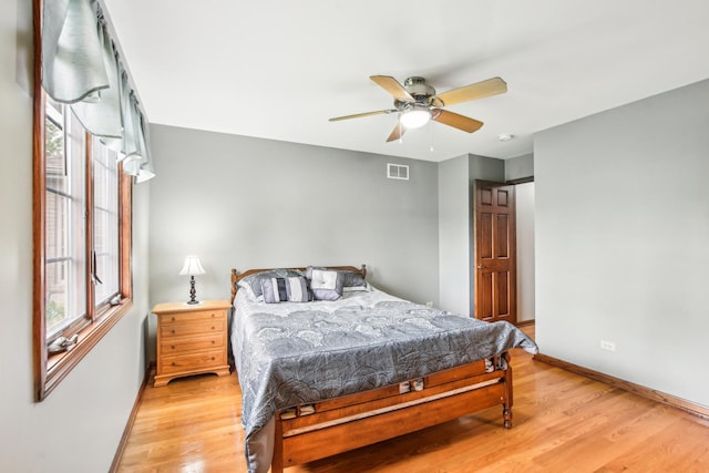 3840 W Nettle Creek Dr, Morris, IL 60450 - bedroom with multiple windows, light wood-style flooring, and baseboards