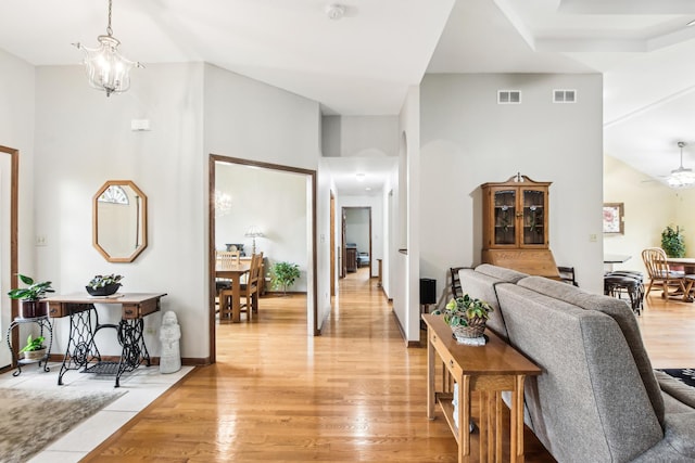 3840 W Nettle Creek Dr, Morris, IL 60450 - living area with a towering ceiling, light wood-style floors, and a chandelier