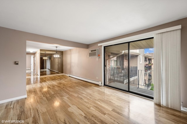 5327 N Delphia Ave Unit 327, Chicago, IL 60656 - spare room with a baseboard heating unit, wood finished floors, a chandelier, and healthy amount of natural light