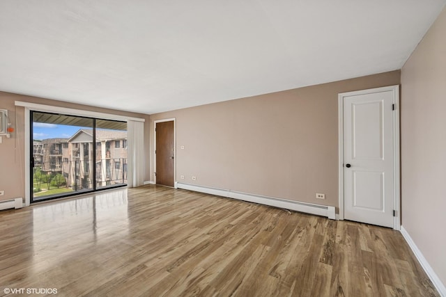 5327 N Delphia Ave Unit 327, Chicago, IL 60656 - empty room with a baseboard radiator and wood finished floors