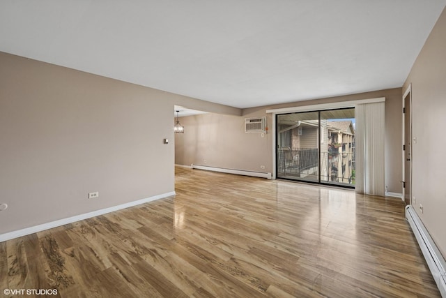 5327 N Delphia Ave Unit 327, Chicago, IL 60656 - unfurnished room with a baseboard radiator, wood finished floors, a wall mounted AC, and a chandelier