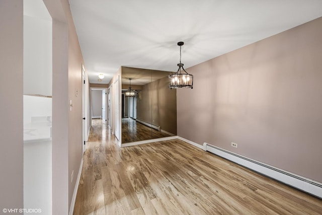 5327 N Delphia Ave Unit 327, Chicago, IL 60656 - unfurnished dining area featuring a baseboard radiator, a chandelier, wood finished floors, and baseboard heating