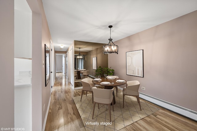 5327 N Delphia Ave Unit 327, Chicago, IL 60656 - dining room with baseboard heating, wood finished floors, and a chandelier