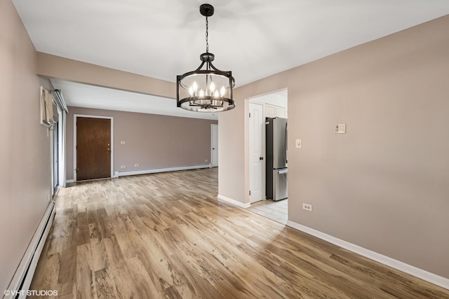 5327 N Delphia Ave Unit 327, Chicago, IL 60656 - unfurnished room with a baseboard radiator, a chandelier, and light wood-style flooring