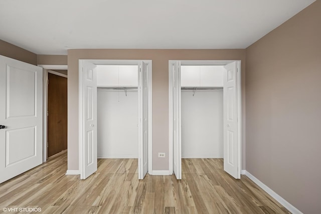 5327 N Delphia Ave Unit 327, Chicago, IL 60656 - unfurnished bedroom with multiple closets and light wood-style floors