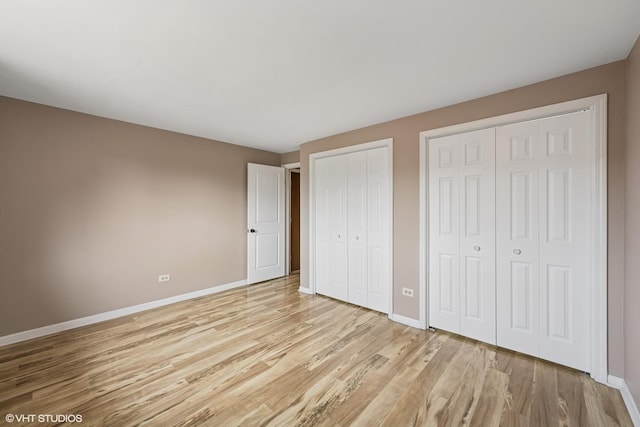 5327 N Delphia Ave Unit 327, Chicago, IL 60656 - unfurnished bedroom featuring multiple closets and light wood finished floors