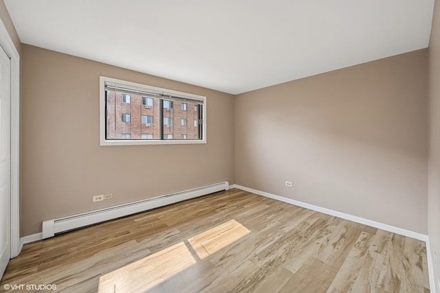 5327 N Delphia Ave Unit 327, Chicago, IL 60656 - spare room with a baseboard heating unit and wood finished floors