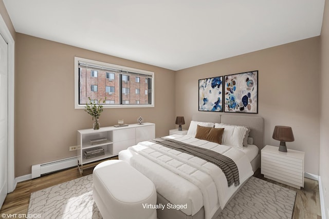 5327 N Delphia Ave Unit 327, Chicago, IL 60656 - bedroom with baseboard heating and light wood-type flooring