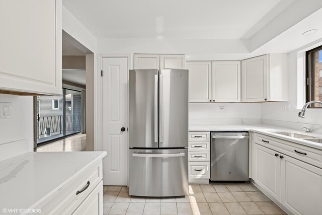 5327 N Delphia Ave Unit 327, Chicago, IL 60656 - kitchen featuring appliances with stainless steel finishes, white cabinets, light tile patterned floors, and light stone counters