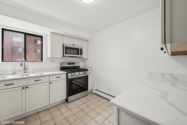 5327 N Delphia Ave Unit 327, Chicago, IL 60656 - kitchen with stainless steel appliances, baseboard heating, white cabinets, and light stone counters