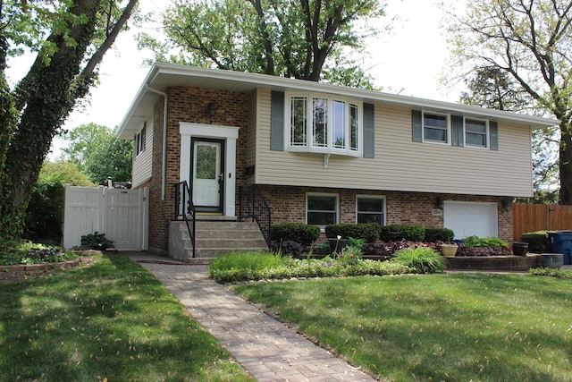 raised ranch featuring brick siding and an attached garage
