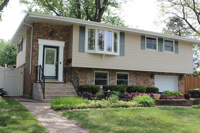 view of front of property featuring brick siding and an attached garage