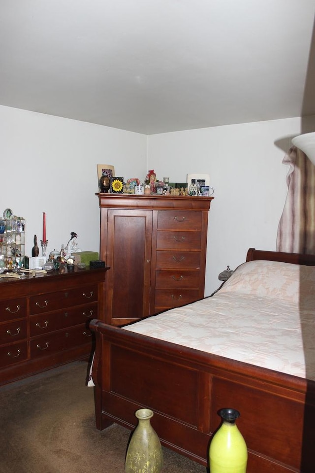 bedroom featuring dark carpet