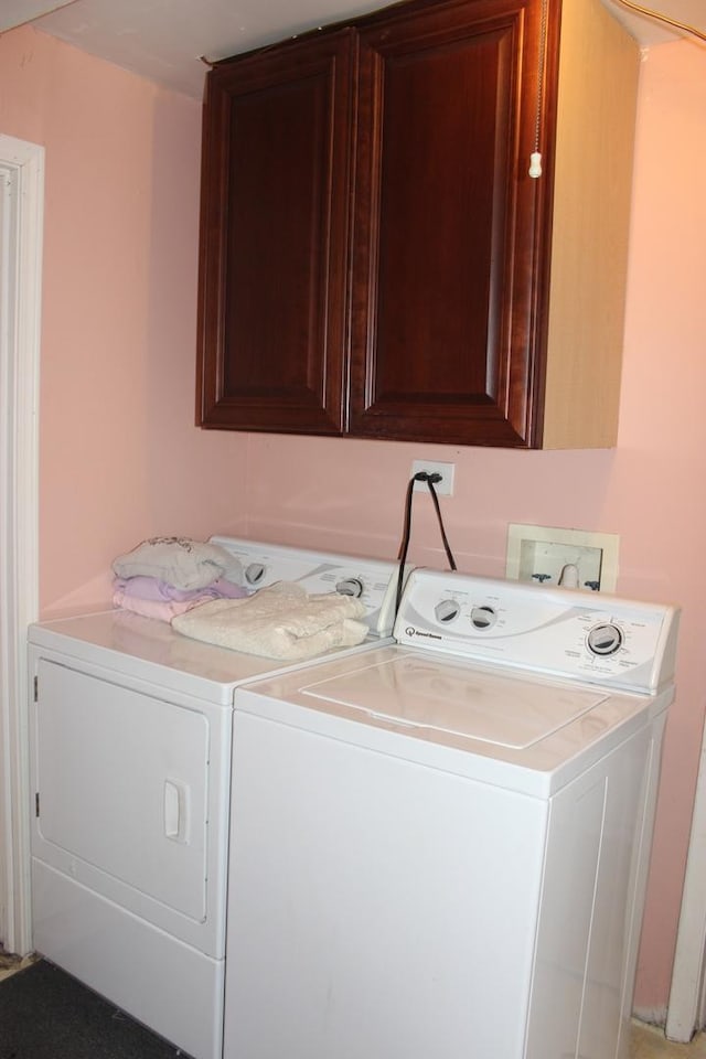 washroom featuring washer and clothes dryer and cabinet space