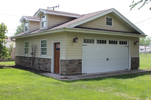 view of home's exterior with stone siding and a shingled roof