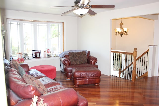 living room featuring a chandelier, wood finished floors, and a ceiling fan