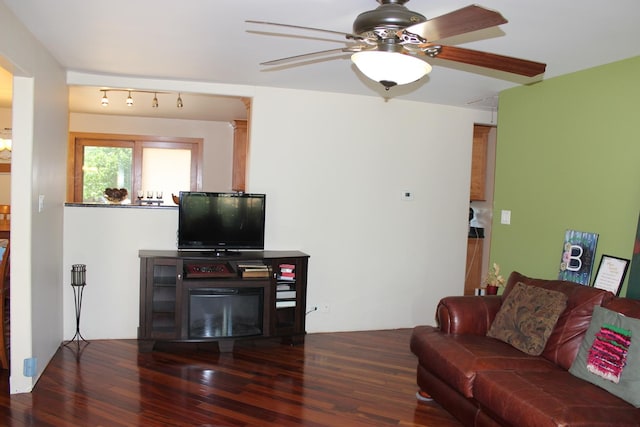 living area featuring wood finished floors and a ceiling fan