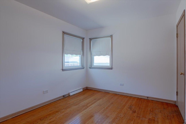 4717 N Newcastle Ave, Harwood Heights, IL 60706 - spare room with baseboard heating, light wood-style flooring, and baseboards