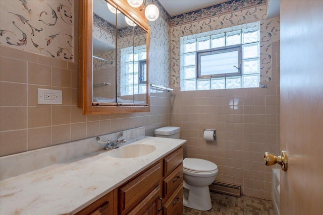 4717 N Newcastle Ave, Harwood Heights, IL 60706 - full bath featuring tile walls, wallpapered walls, a baseboard heating unit, toilet, and vanity