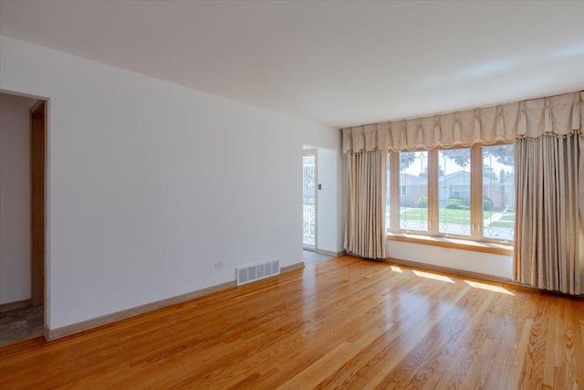 4717 N Newcastle Ave, Harwood Heights, IL 60706 - unfurnished room with light wood-style flooring and baseboards