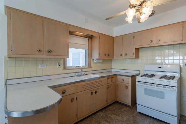 4717 N Newcastle Ave, Harwood Heights, IL 60706 - kitchen featuring white gas range, a sink, ceiling fan, and tasteful backsplash