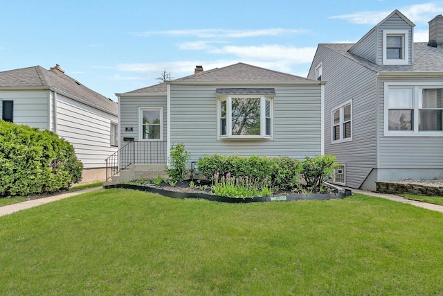 3811 N Pioneer Ave, Chicago, IL 60634 - view of front of property with a front lawn, a chimney, and a shingled roof