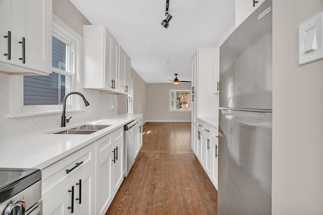 3811 N Pioneer Ave, Chicago, IL 60634 - kitchen with appliances with stainless steel finishes, a sink, white cabinets, and light countertops