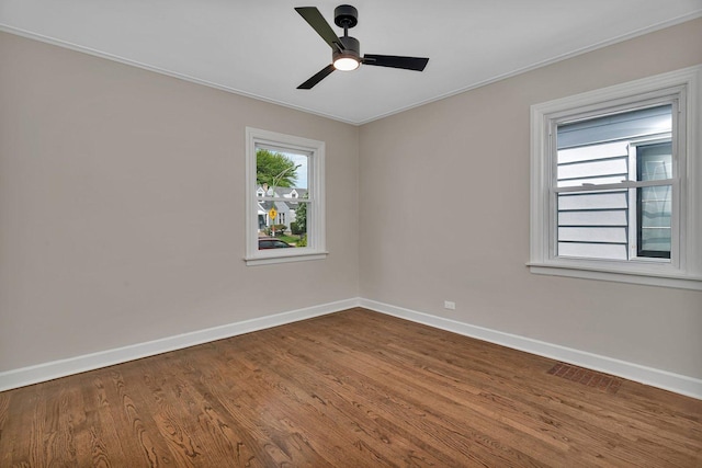 3811 N Pioneer Ave, Chicago, IL 60634 - spare room with baseboards, a ceiling fan, dark wood-type flooring, and ornamental molding