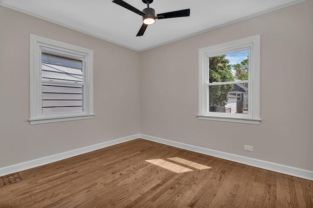 3811 N Pioneer Ave, Chicago, IL 60634 - empty room with baseboards, wood finished floors, crown molding, and ceiling fan