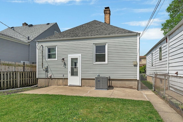 3811 N Pioneer Ave, Chicago, IL 60634 - back of house featuring cooling unit, roof with shingles, a chimney, and a patio