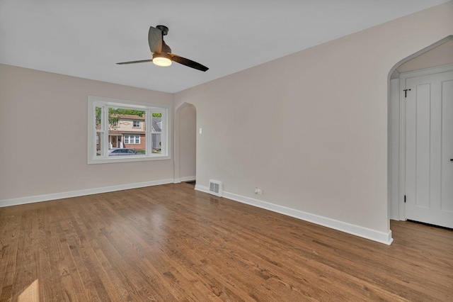 3811 N Pioneer Ave, Chicago, IL 60634 - spare room with arched walkways, wood finished floors, and ceiling fan