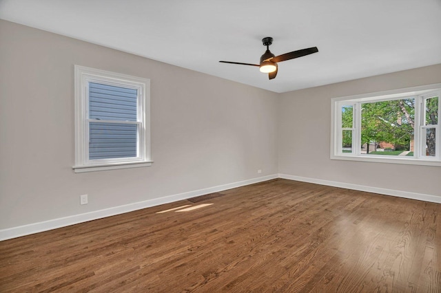 3811 N Pioneer Ave, Chicago, IL 60634 - spare room featuring dark wood finished floors, baseboards, and ceiling fan