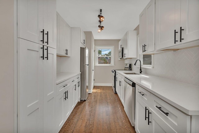 3811 N Pioneer Ave, Chicago, IL 60634 - kitchen featuring stainless steel appliances, a sink, tasteful backsplash, dark wood-type flooring, and white cabinetry