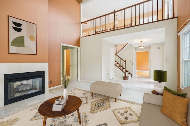 1924 W Ashbury Ln, Inverness, IL 60067 - living area with a towering ceiling, stairway, a tiled fireplace, and baseboards