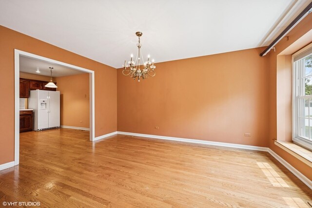 1924 W Ashbury Ln, Inverness, IL 60067 - unfurnished room with light wood-type flooring, a chandelier, and baseboards