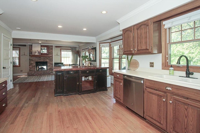 5 Piper Ln, Hawthorn Woods, IL 60047 - kitchen with dishwasher, a sink, light wood-style flooring, a brick fireplace, and crown molding