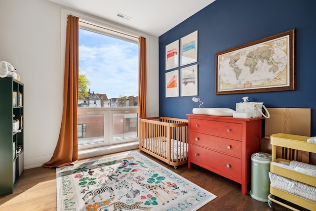 3101 N Ridgeway Ave Unit 2C, Chicago, IL 60618 - bedroom featuring multiple windows, wood finished floors, and a crib