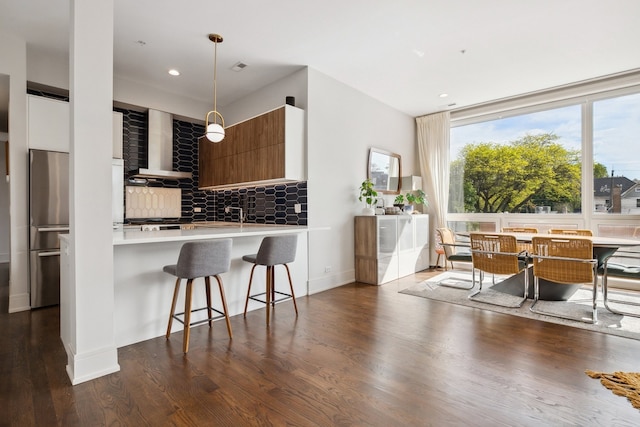 3101 N Ridgeway Ave Unit 2C, Chicago, IL 60618 - kitchen with wall chimney exhaust hood, stainless steel refrigerator, tasteful backsplash, dark wood-style floors, and modern cabinets