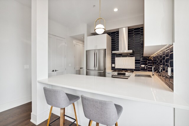 3101 N Ridgeway Ave Unit 2C, Chicago, IL 60618 - kitchen with stainless steel appliances, wall chimney exhaust hood, a sink, pendant lighting, and light countertops