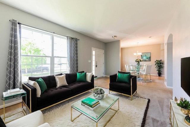 433 Minuet Cir, Volo, IL 60073 - carpeted living room featuring arched walkways, a chandelier, and baseboards