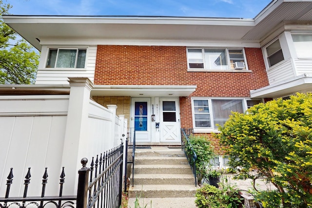 5411 N Artesian Ave, Chicago, IL 60625 - view of front facade with brick siding, cooling unit, and fence