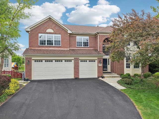 2913 Glenarye Dr, Lindenhurst, IL 60046 - traditional home with asphalt driveway, brick siding, a shingled roof, and a garage