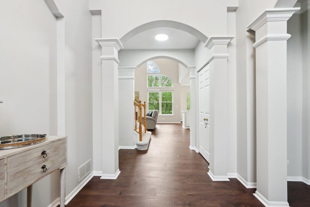 2913 Glenarye Dr, Lindenhurst, IL 60046 - hall featuring arched walkways, dark wood-style floors, decorative columns, and baseboards