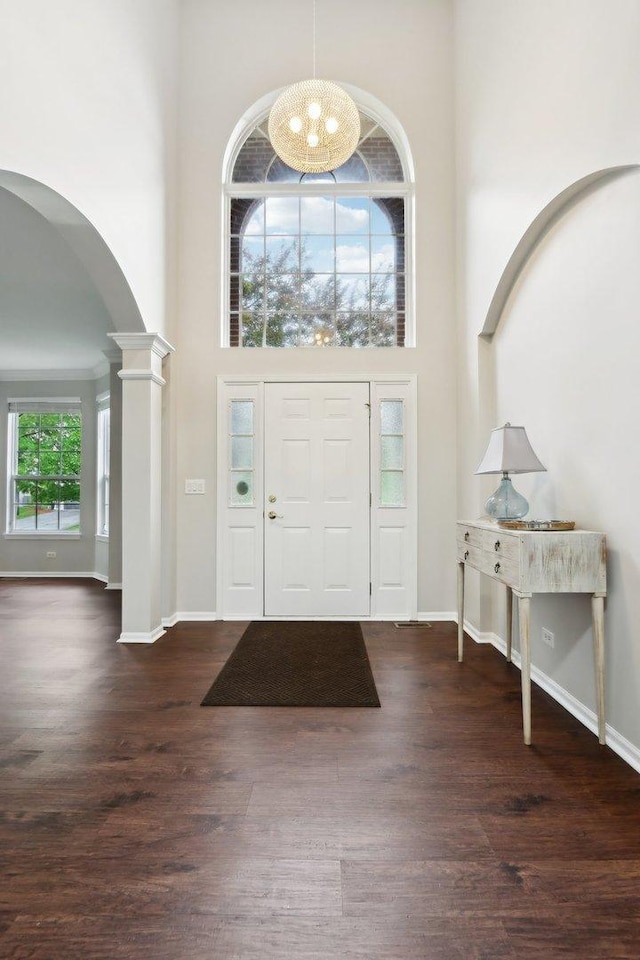 2913 Glenarye Dr, Lindenhurst, IL 60046 - foyer featuring arched walkways, a towering ceiling, wood finished floors, baseboards, and ornate columns
