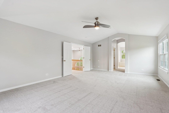 2913 Glenarye Dr, Lindenhurst, IL 60046 - empty room with a ceiling fan, arched walkways, lofted ceiling, light colored carpet, and baseboards
