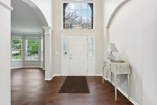 2913 Glenarye Dr, Lindenhurst, IL 60046 - entrance foyer with arched walkways, dark wood finished floors, ornate columns, and baseboards